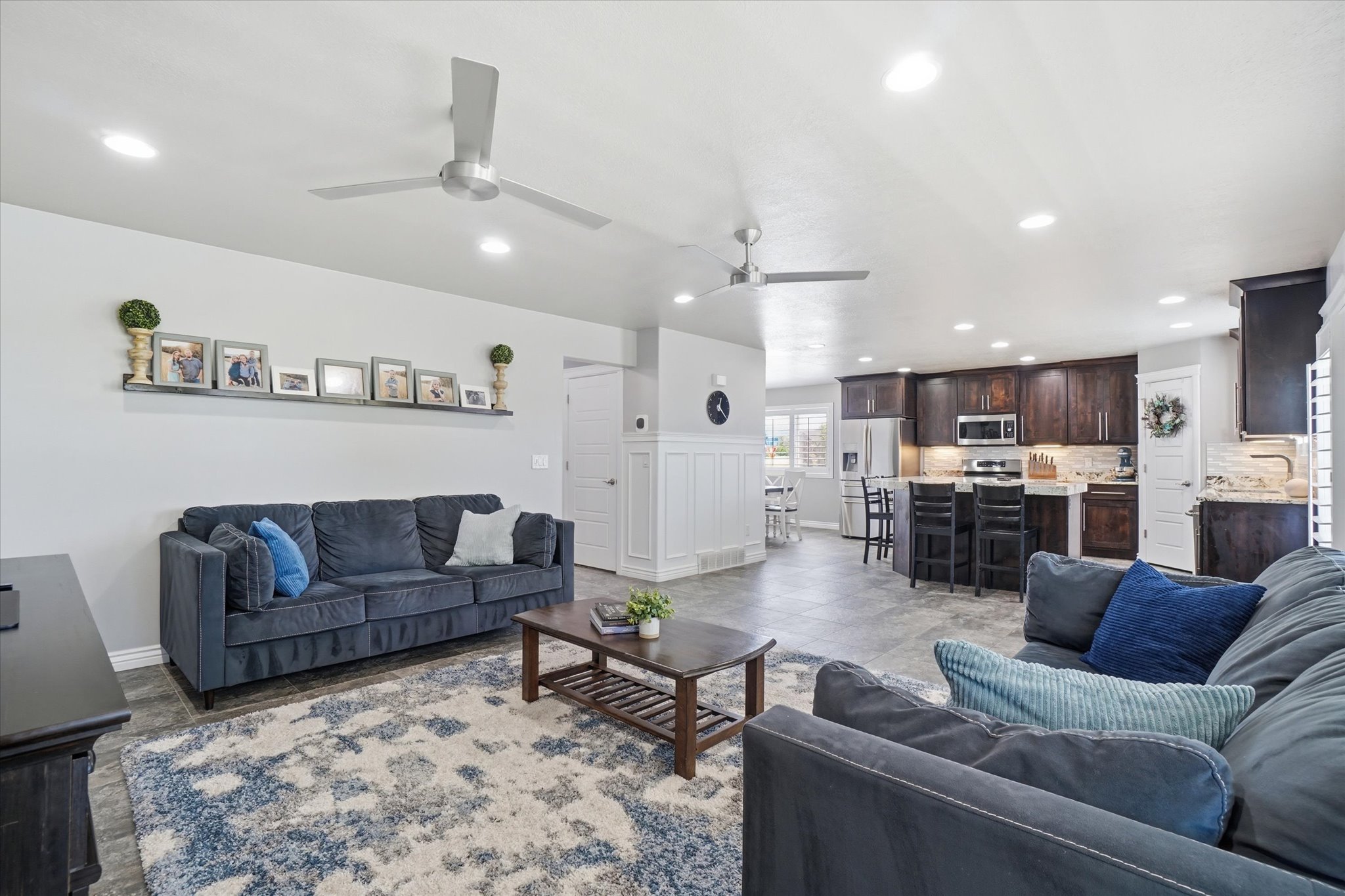 Open-concept living area with recessed lighting and two ceiling fans