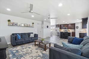 Open-concept living area with recessed lighting and two ceiling fans