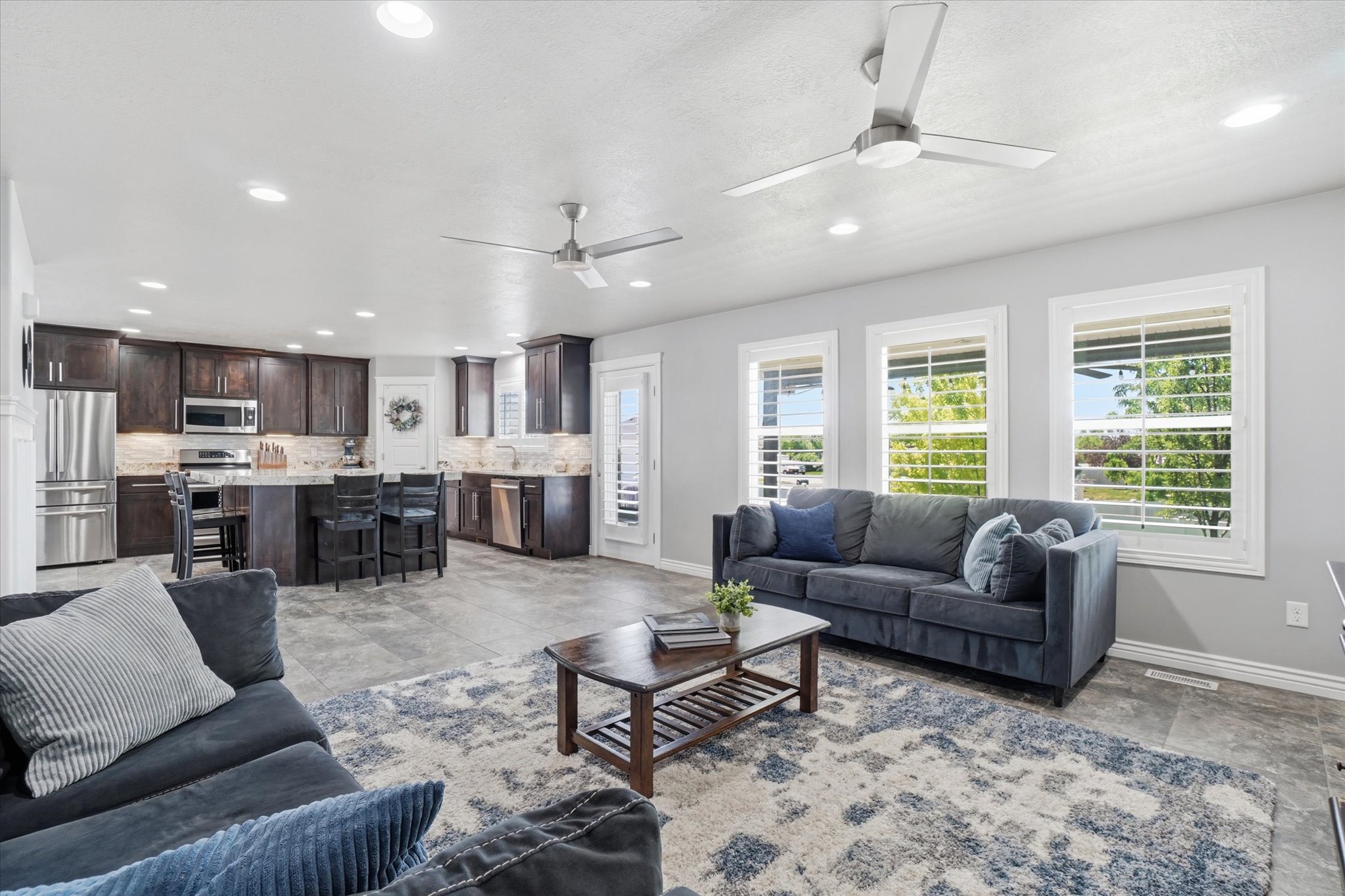 Spacious open-concept living area featuring wood-finish flooring and recessed lighting