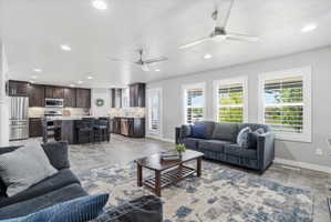 Spacious open-concept living area featuring wood-finish flooring and recessed lighting
