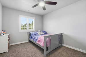 Room featuring neutral wall tones, carpeted flooring, a window with white louvered shutters, and a ceiling fan with integrated lighting