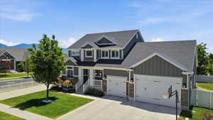 Contemporary two-story residence featuring a striking dark gray siding and white trim exterior