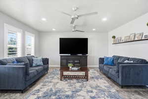 Spacious living area featuring recessed lighting, multiple ceiling fans, and wood-finish flooring