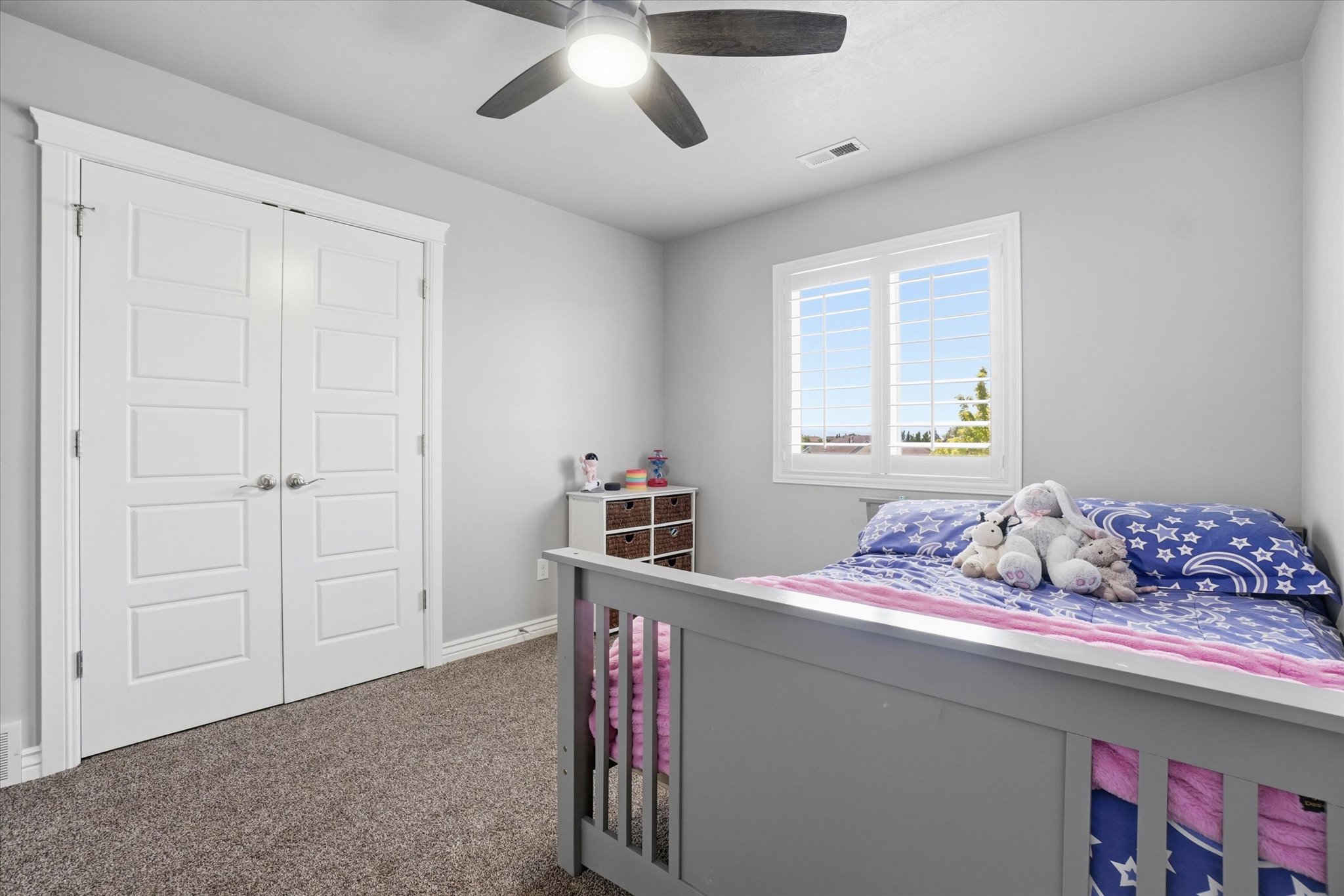 Neutral painted walls complement the carpeted flooring and white trim