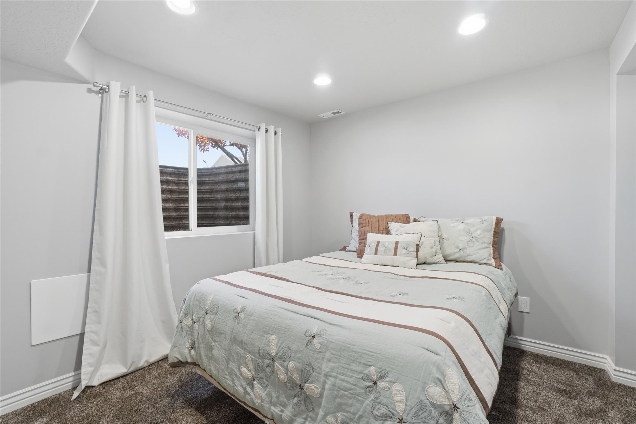 Bedroom featuring recessed lighting, light gray walls, white baseboards, and dark gray carpeting