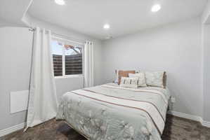 Bedroom featuring recessed lighting, light gray walls, white baseboards, and dark gray carpeting