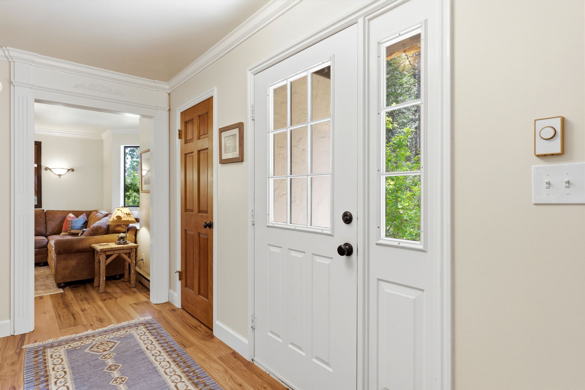 Entryway featuring a white paneled door with glass inserts and a sidelight