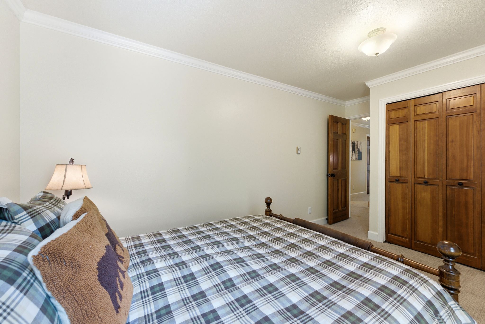 Bedroom featuring light-colored walls and crown molding