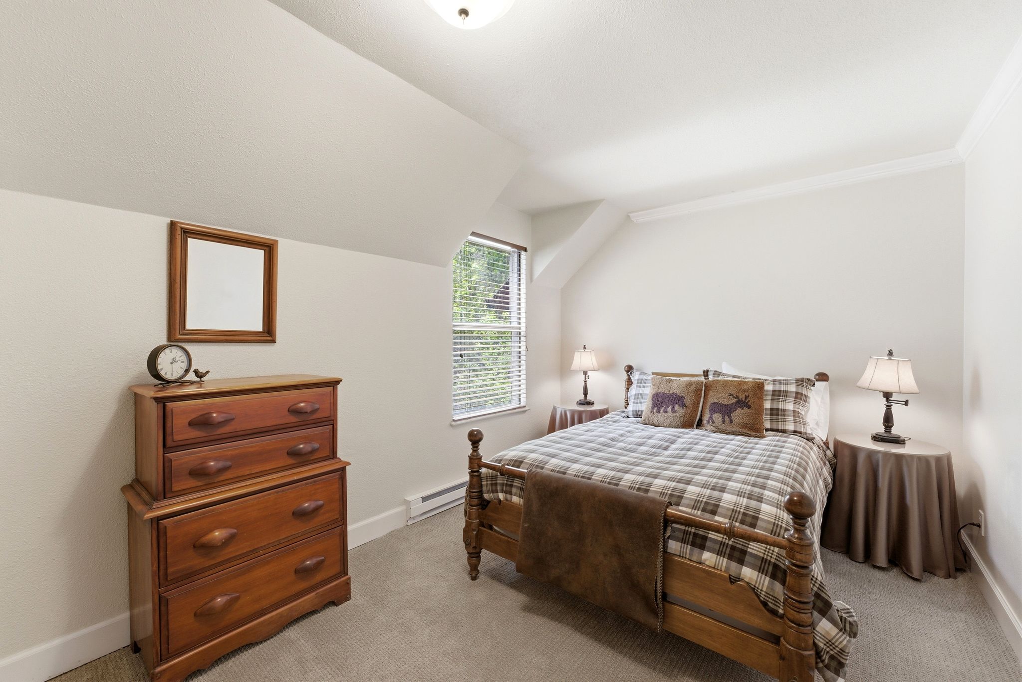 Carpeted room with a pitched ceiling and a window featuring blinds