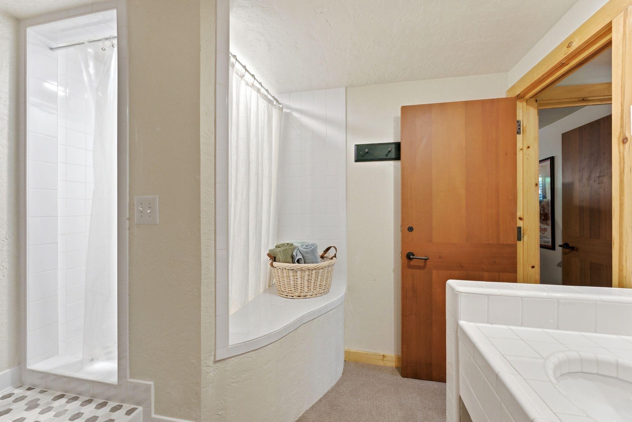 Walk-in shower with pebble-tile flooring and white subway tile surround