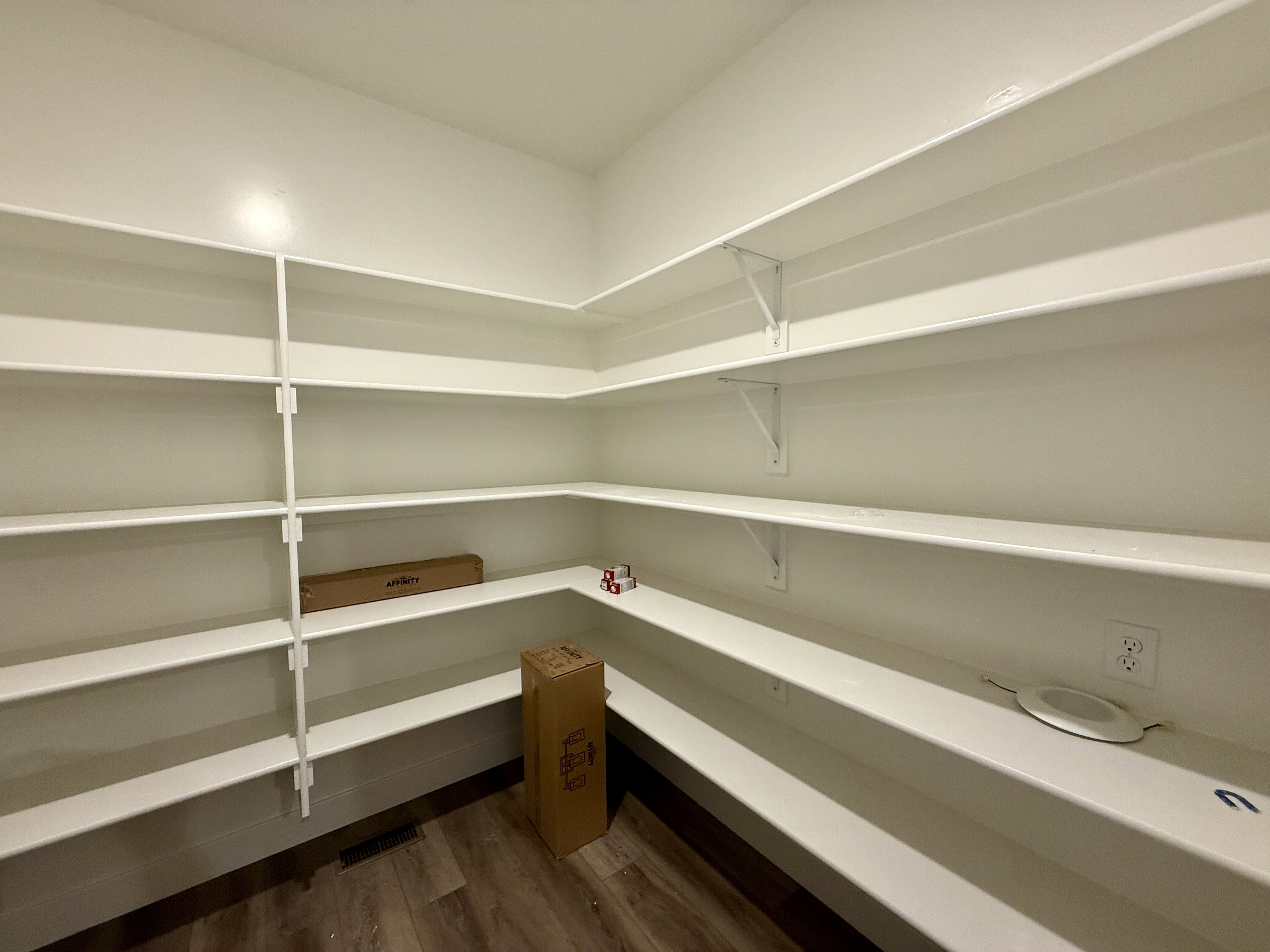 Expansive pantry featuring extensive white shelving