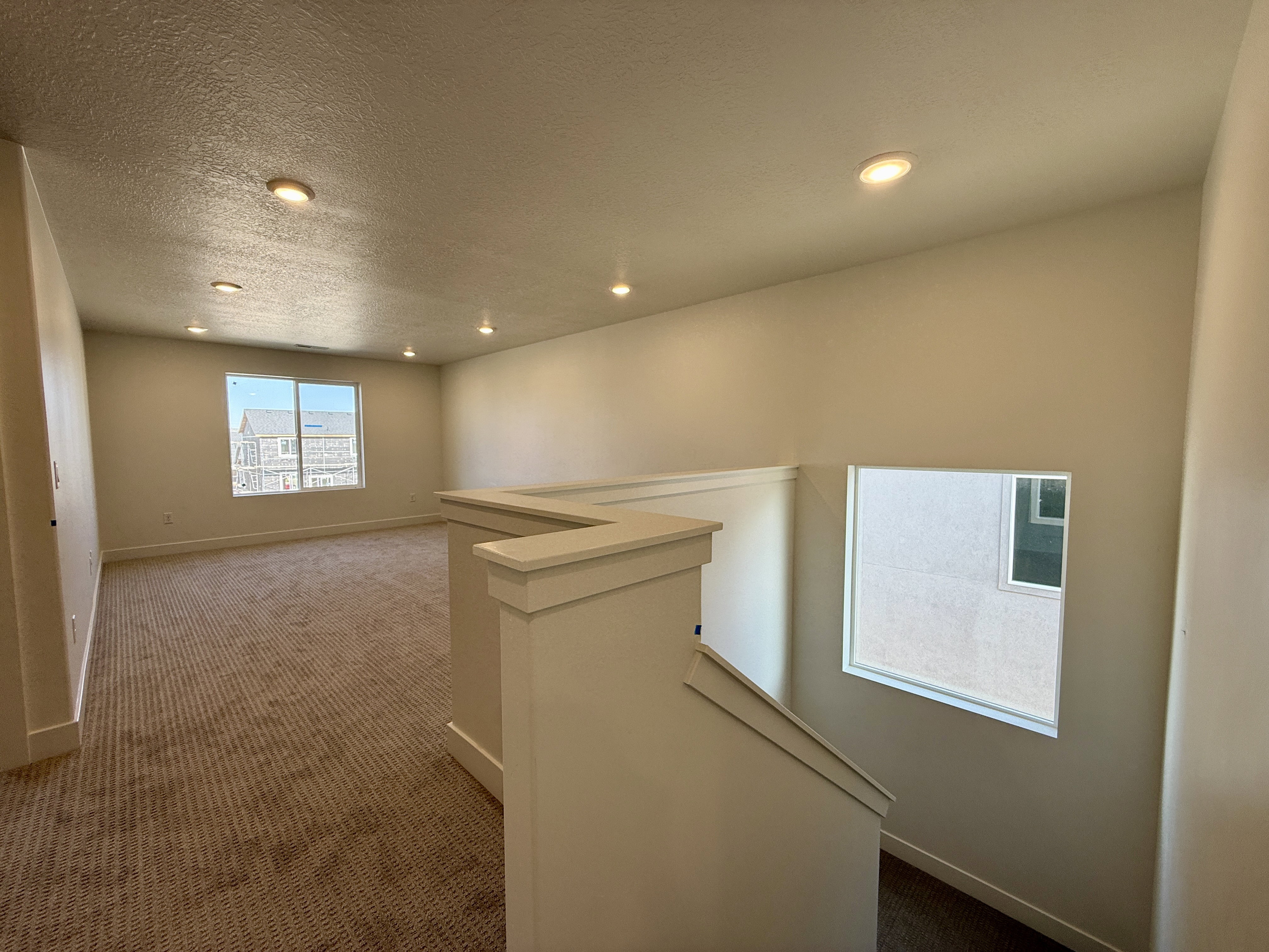 Spacious upper level featuring recessed lighting, neutral wall tones, and carpet flooring