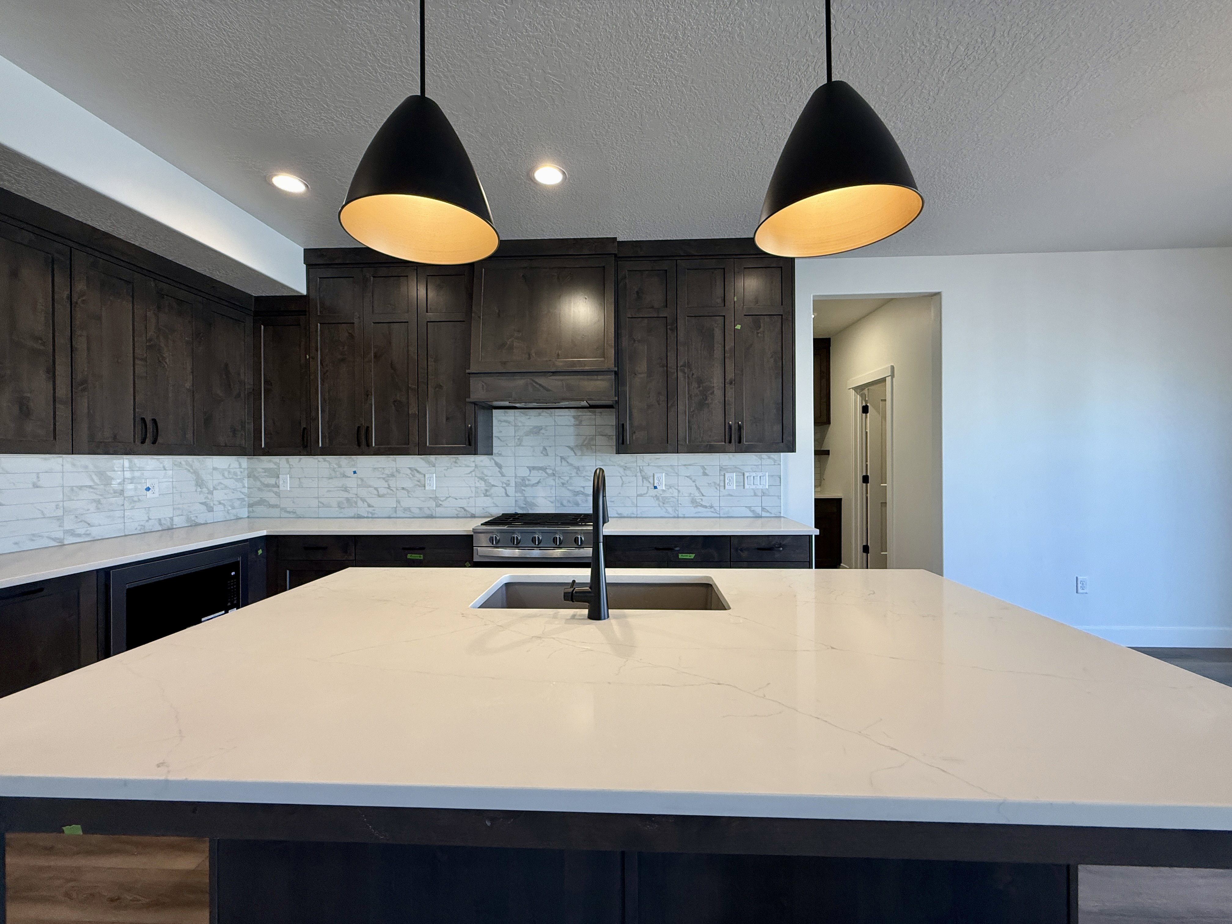 Kitchen island with a built-in sink and matte black faucet