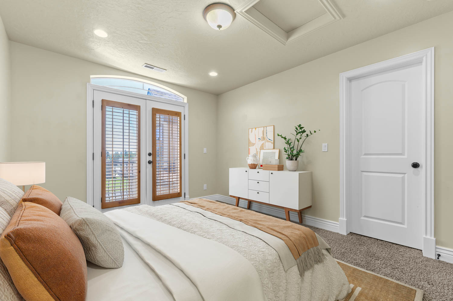 Arched French doors with interior plantation shutters