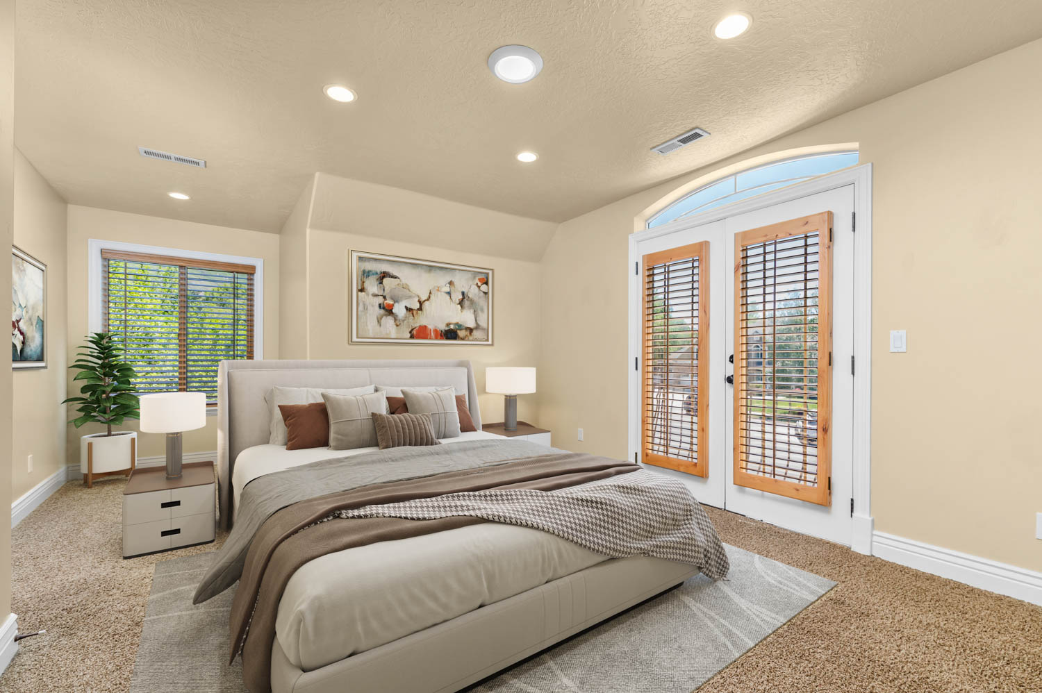 Bedroom featuring warm beige wall tones, recessed lighting, and soft carpet flooring