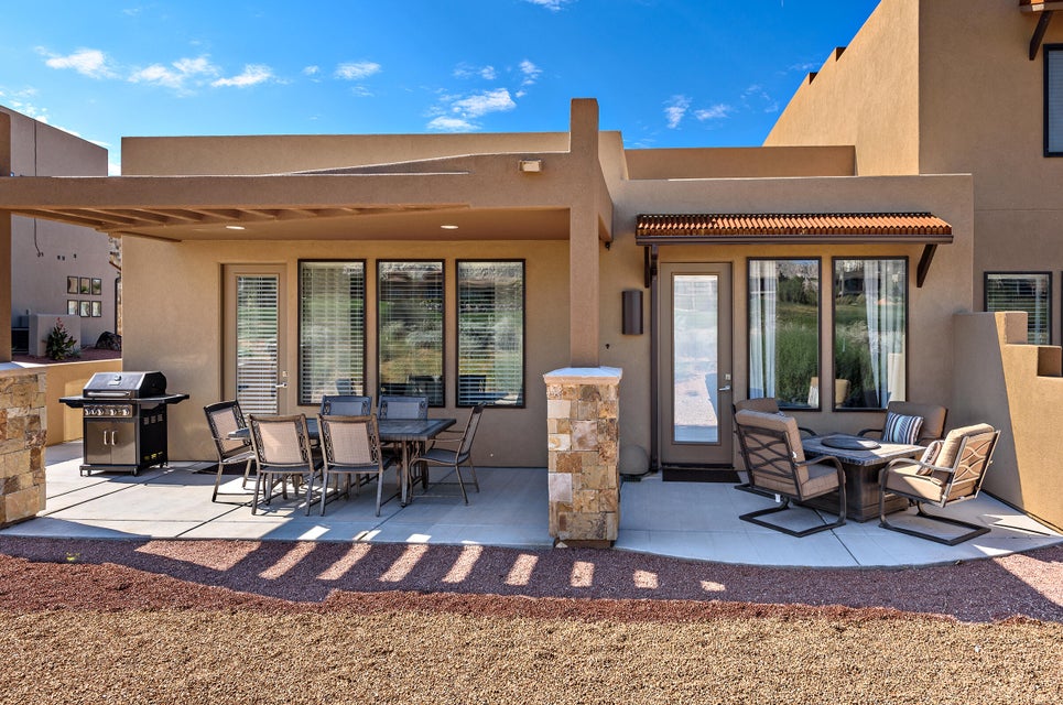 Expansive concrete patio featuring two distinct outdoor living areas