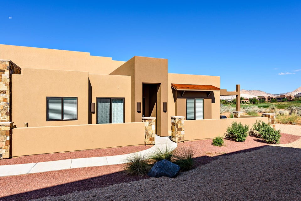 Stucco exterior with stone accents and a covered entryway