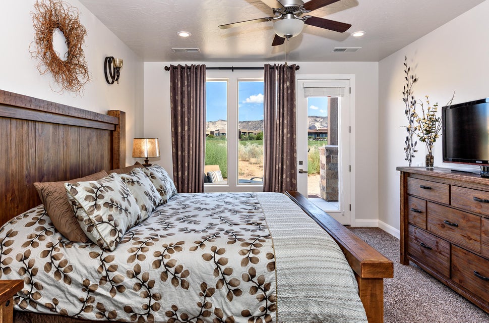 Carpeted interior space featuring a ceiling fan with light fixture, recessed lighting, and a door providing exterior access