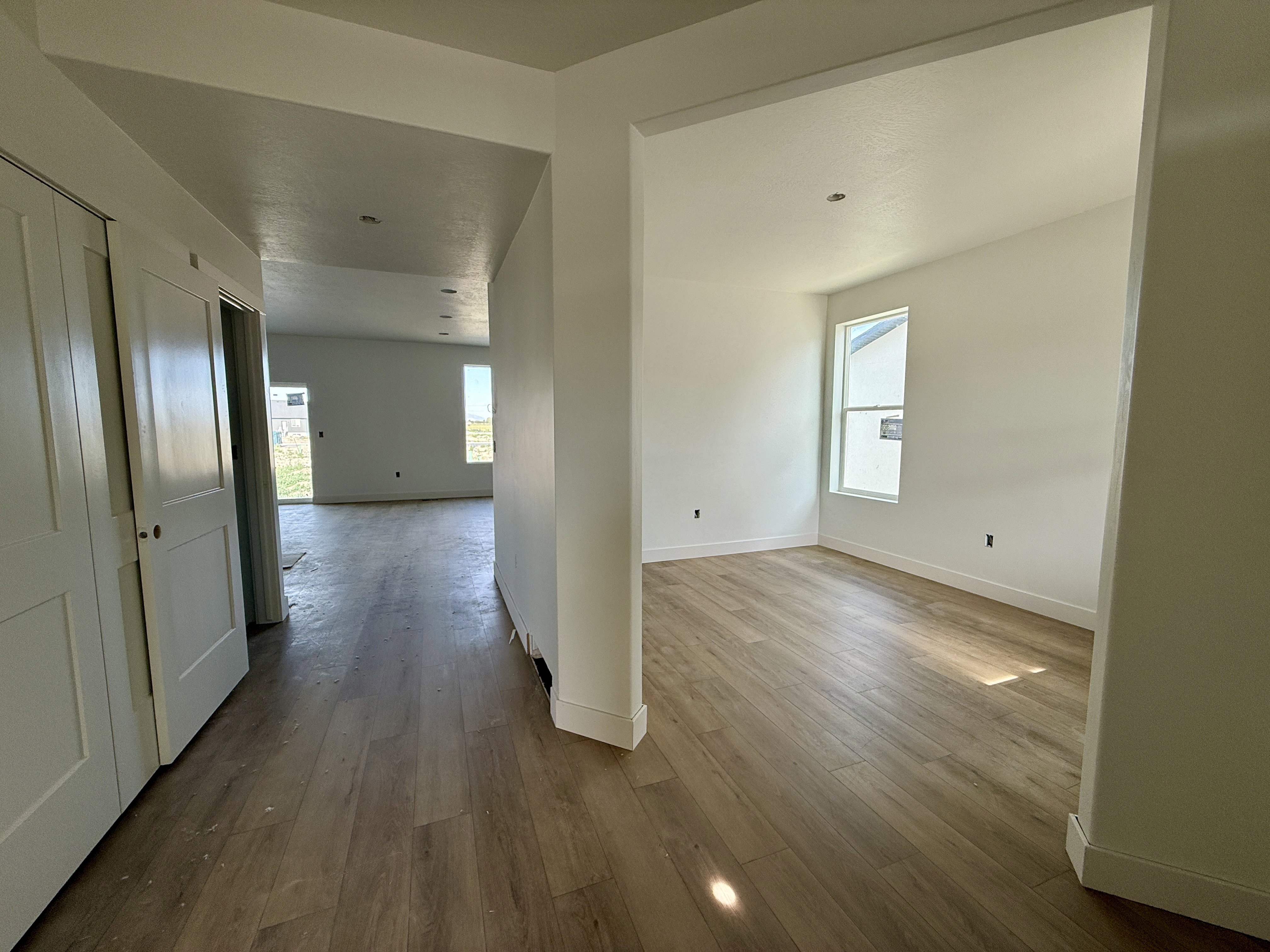 Interior space featuring wood-finish flooring, white walls, and a recessed window