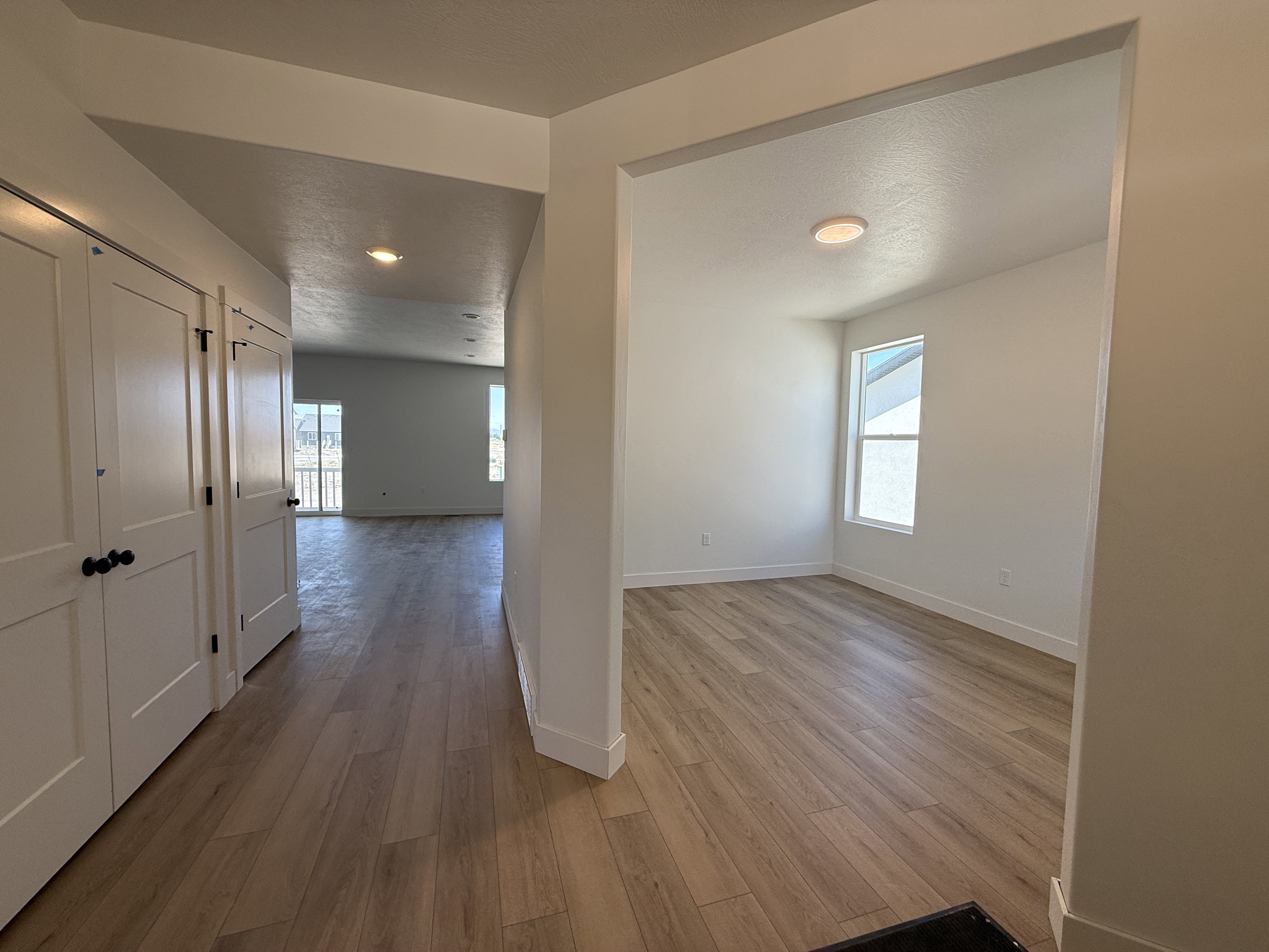 Entryway featuring light wood-finish flooring extending into separate areas