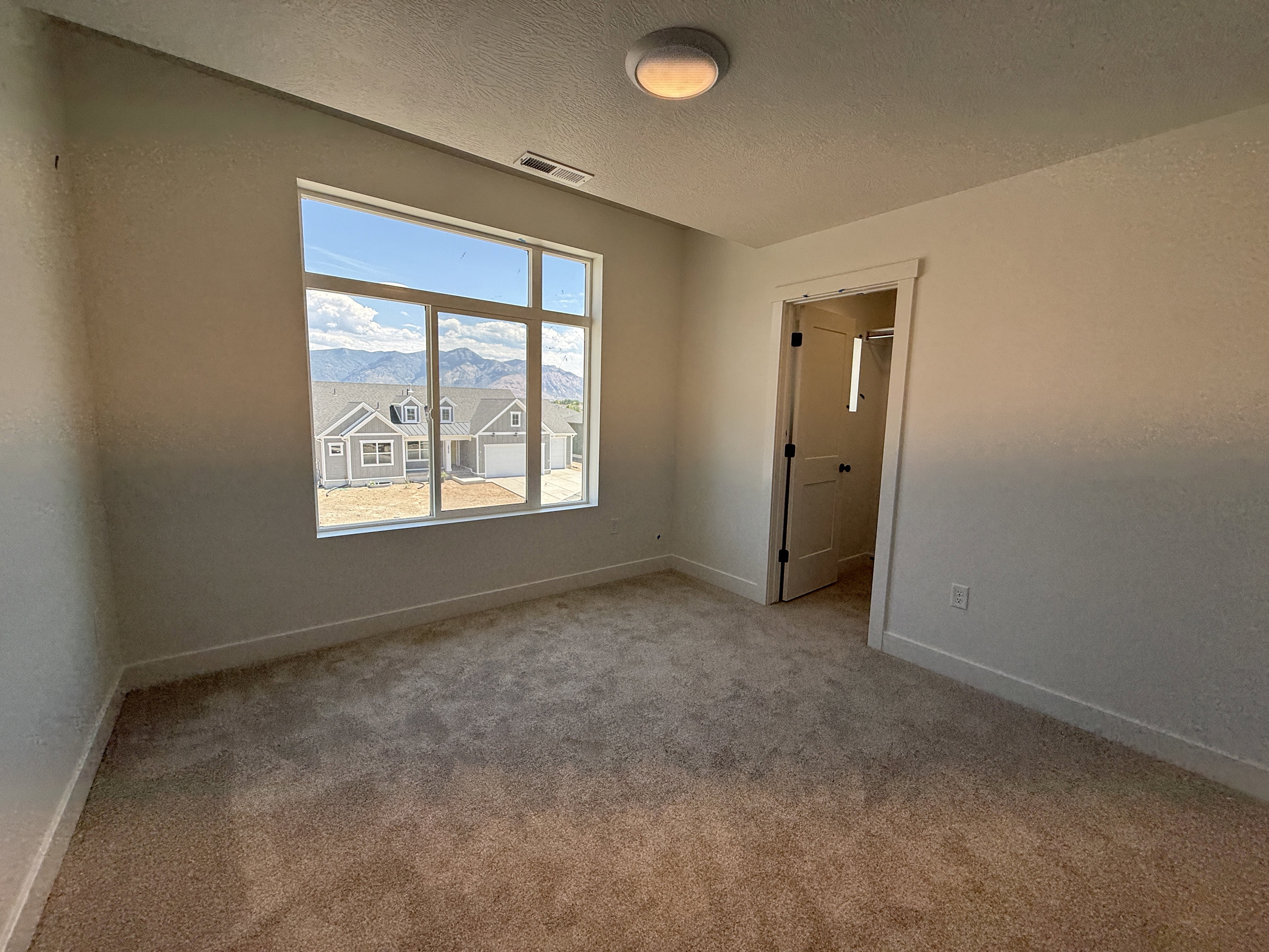 Room featuring broadloom carpeting and neutral wall tones