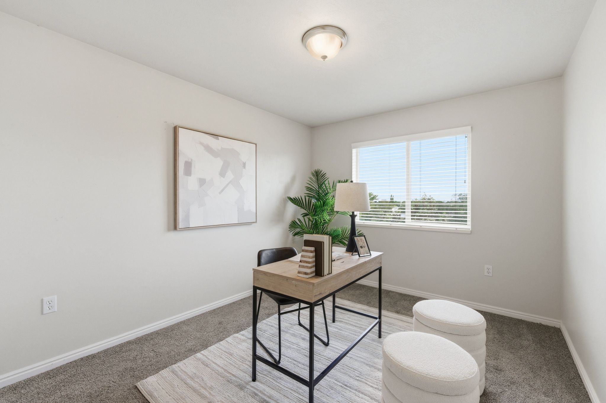 Guest bedroom featuring a single window with horizontal blinds, neutral wall paint, and gray carpet flooring