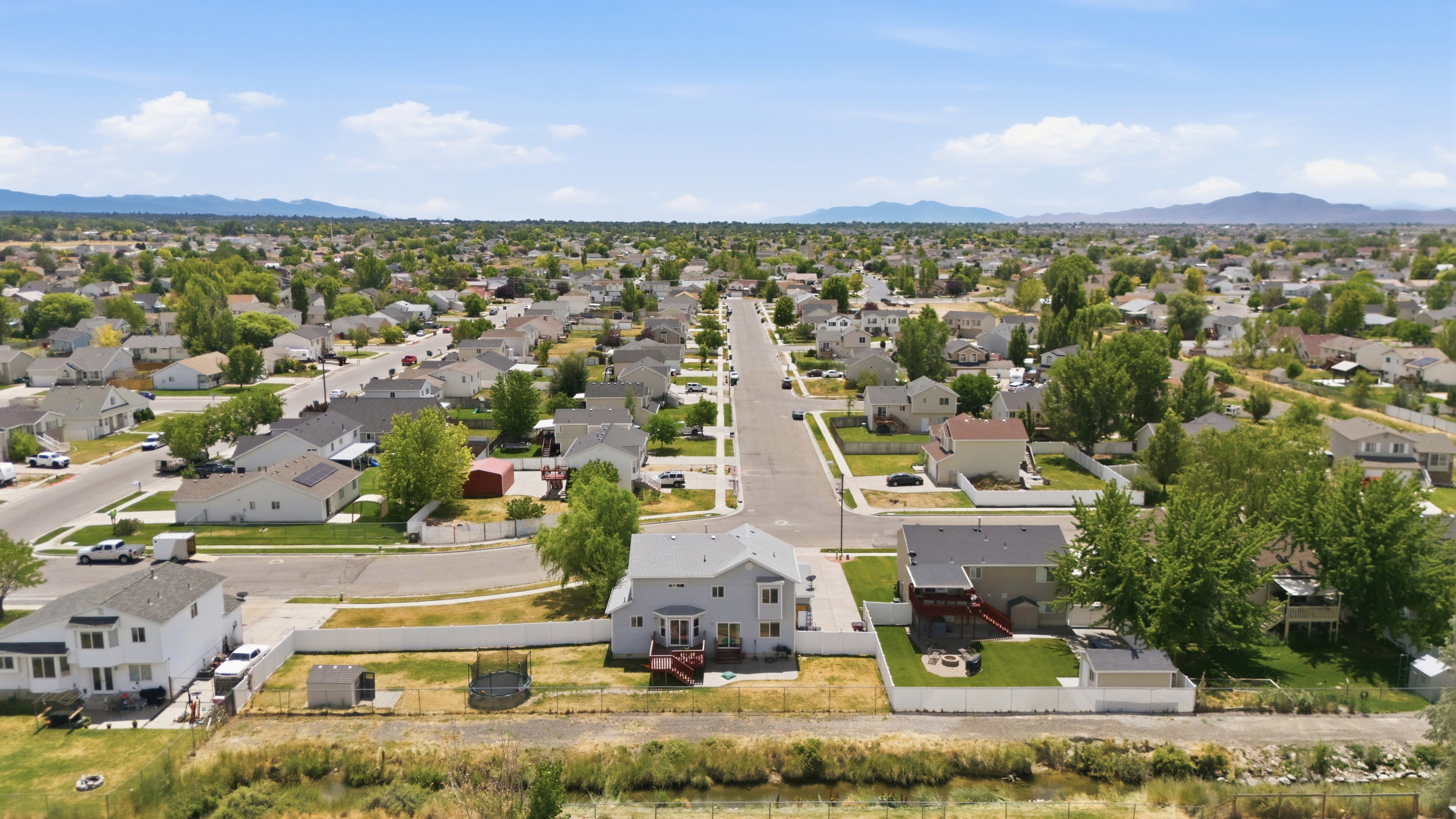Residential neighborhood featuring established homes, paved streets, and mature trees