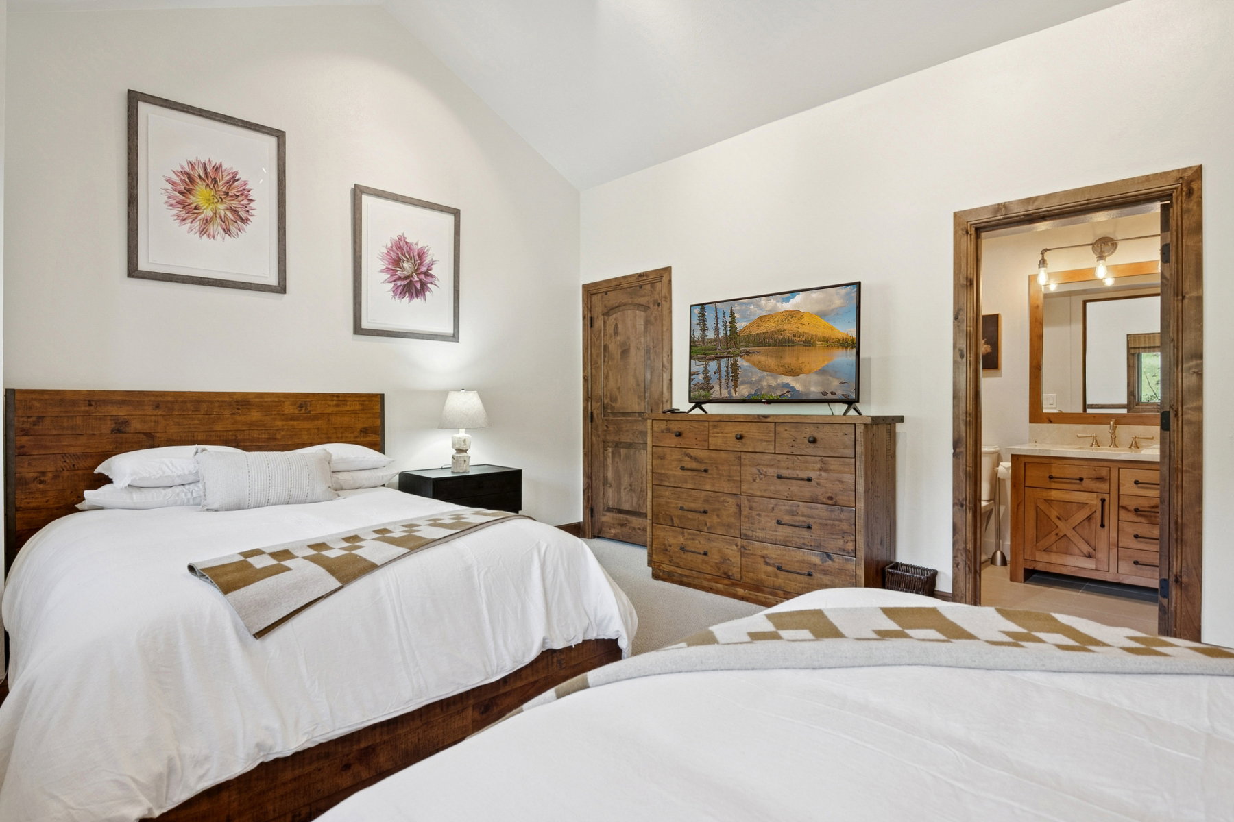 Bedroom featuring a vaulted ceiling and a wood headboard