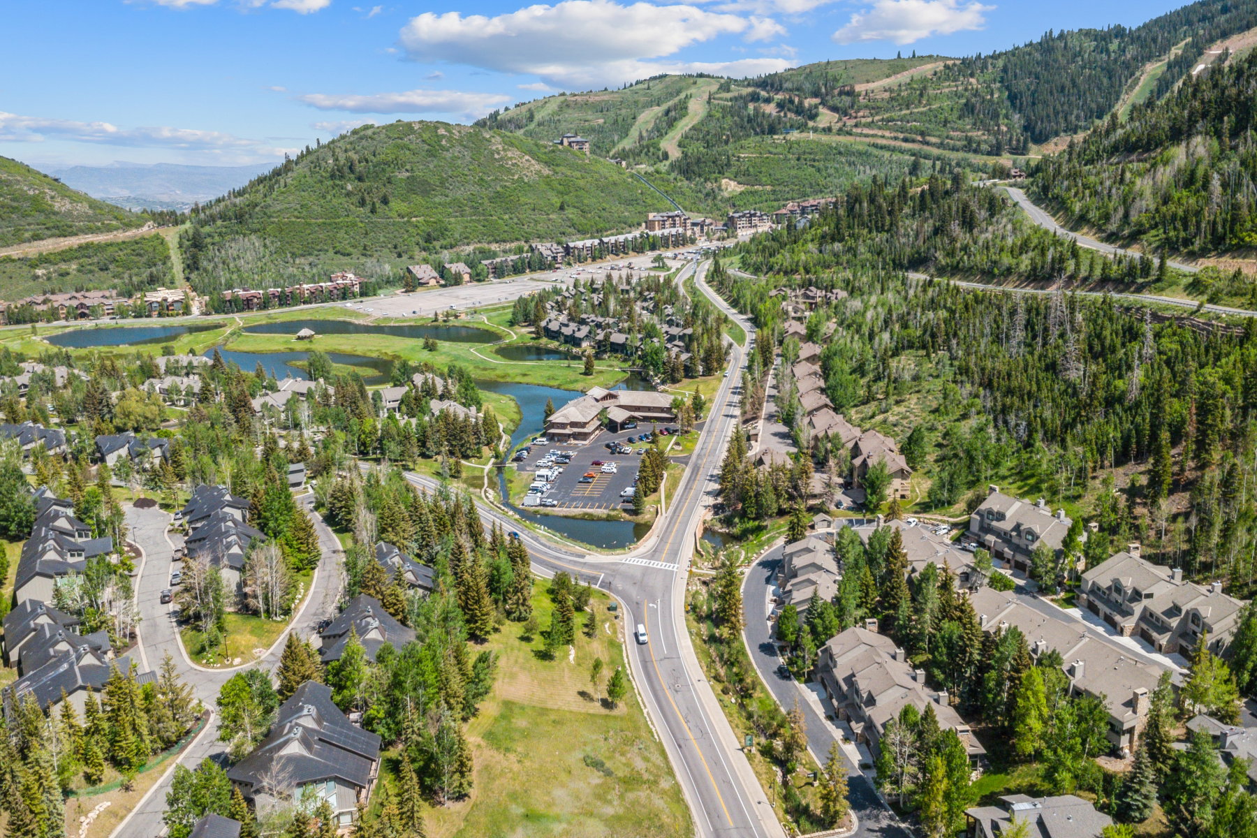 Expansive mountain community featuring multi-story residential structures and lush evergreen trees
