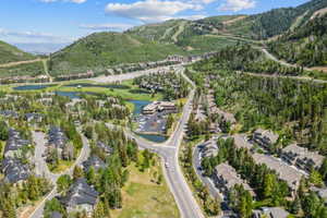 Expansive mountain community featuring multi-story residential structures and lush evergreen trees