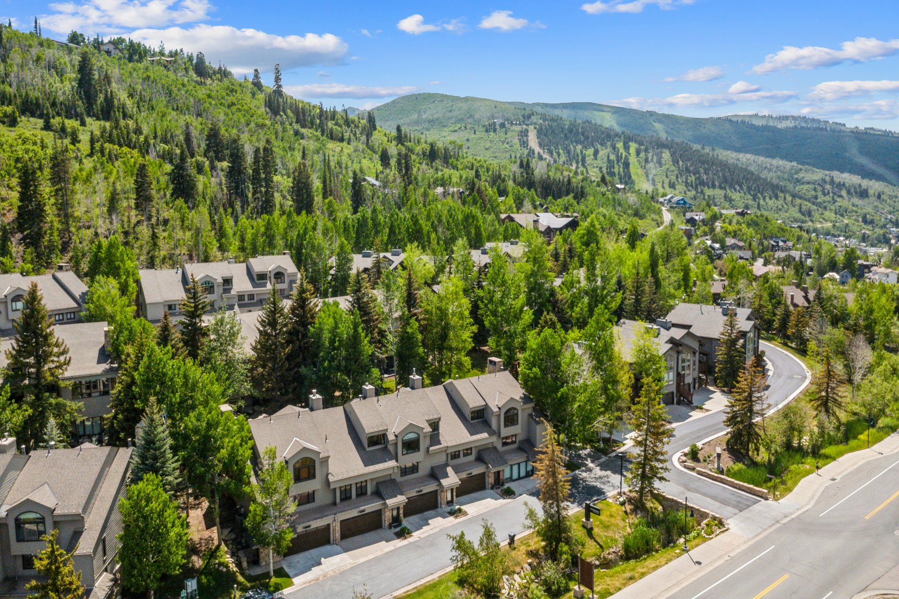 Expansive mountain setting featuring multiple residential buildings with gabled roofs and dormer windows