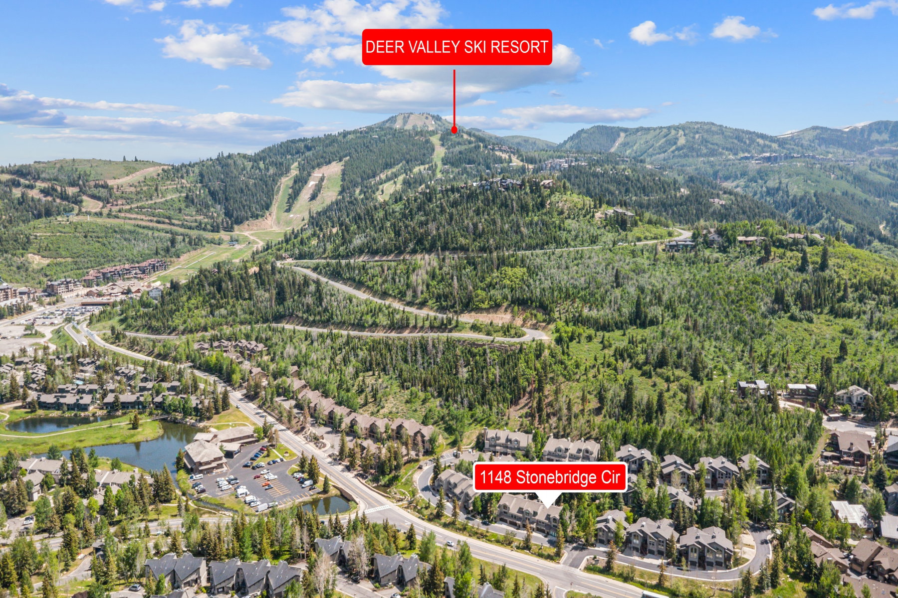Aerial perspective showcasing the surrounding mountainous terrain and residential developments