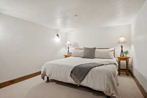 Neutral white walls complement light-toned carpeting and wood-finish baseboards