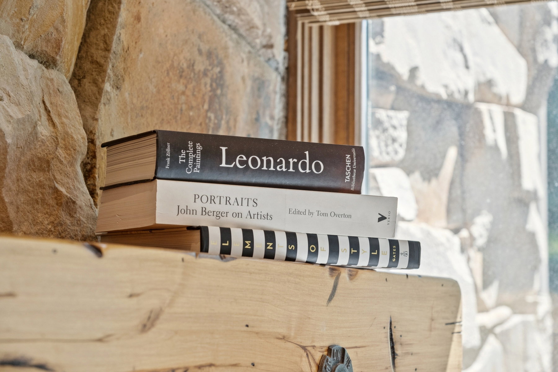 Natural stone wall with rough-hewn texture, featuring a wooden ledge