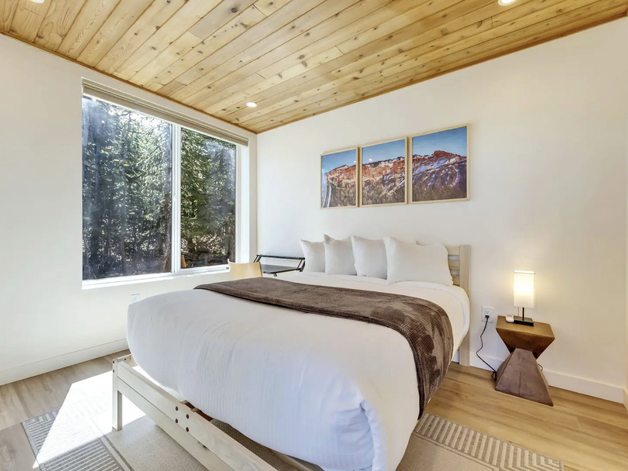 Spacious room featuring a wood-finish ceiling, large picture window, recessed lighting, and light wood-finish flooring