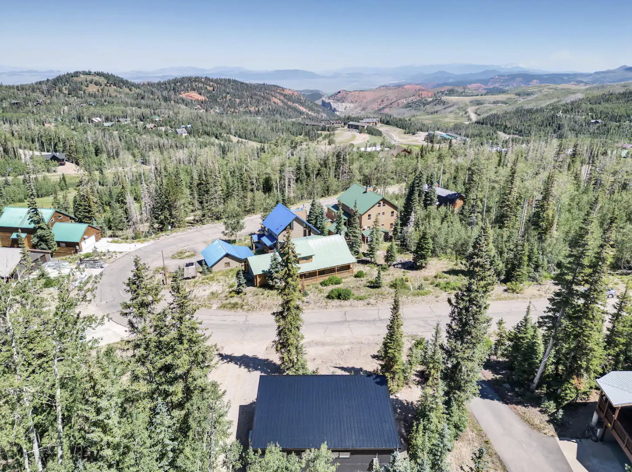 Aerial perspective showcasing a mountain community with surrounding hills and distant ranges