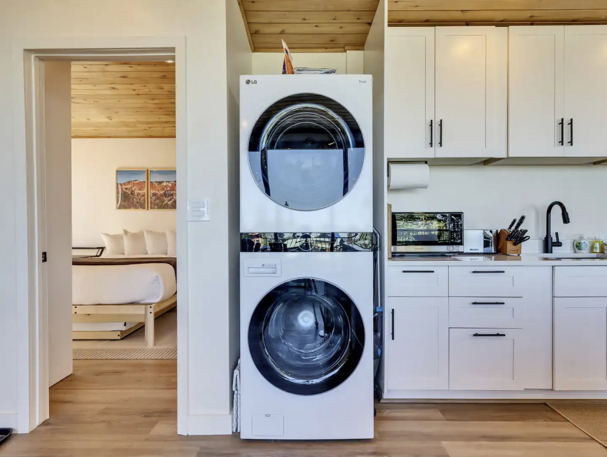 Integrated laundry center with stacked washer and dryer