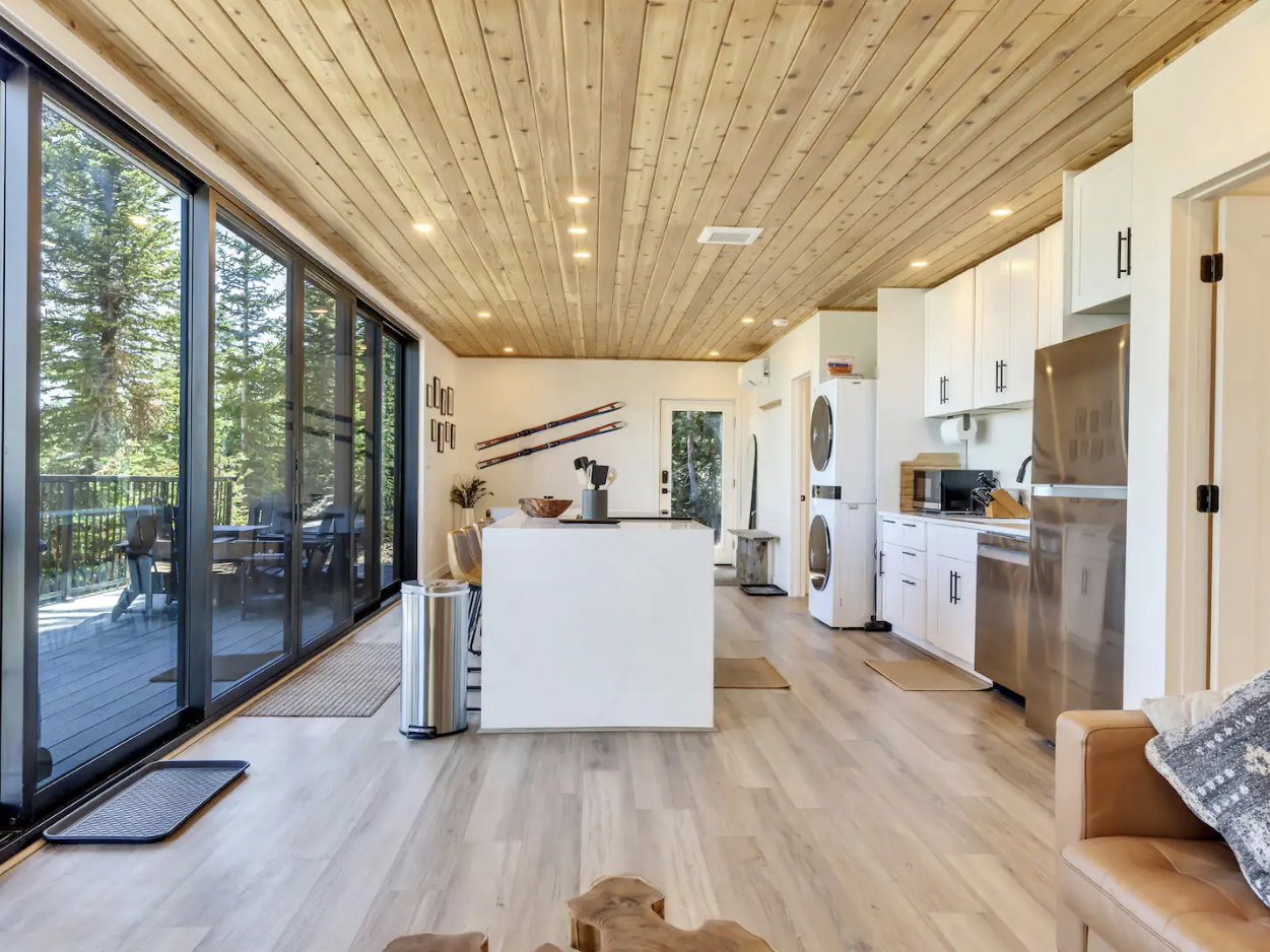Open-concept living area featuring a wood-finish plank ceiling, recessed lighting, and light wood-finish flooring