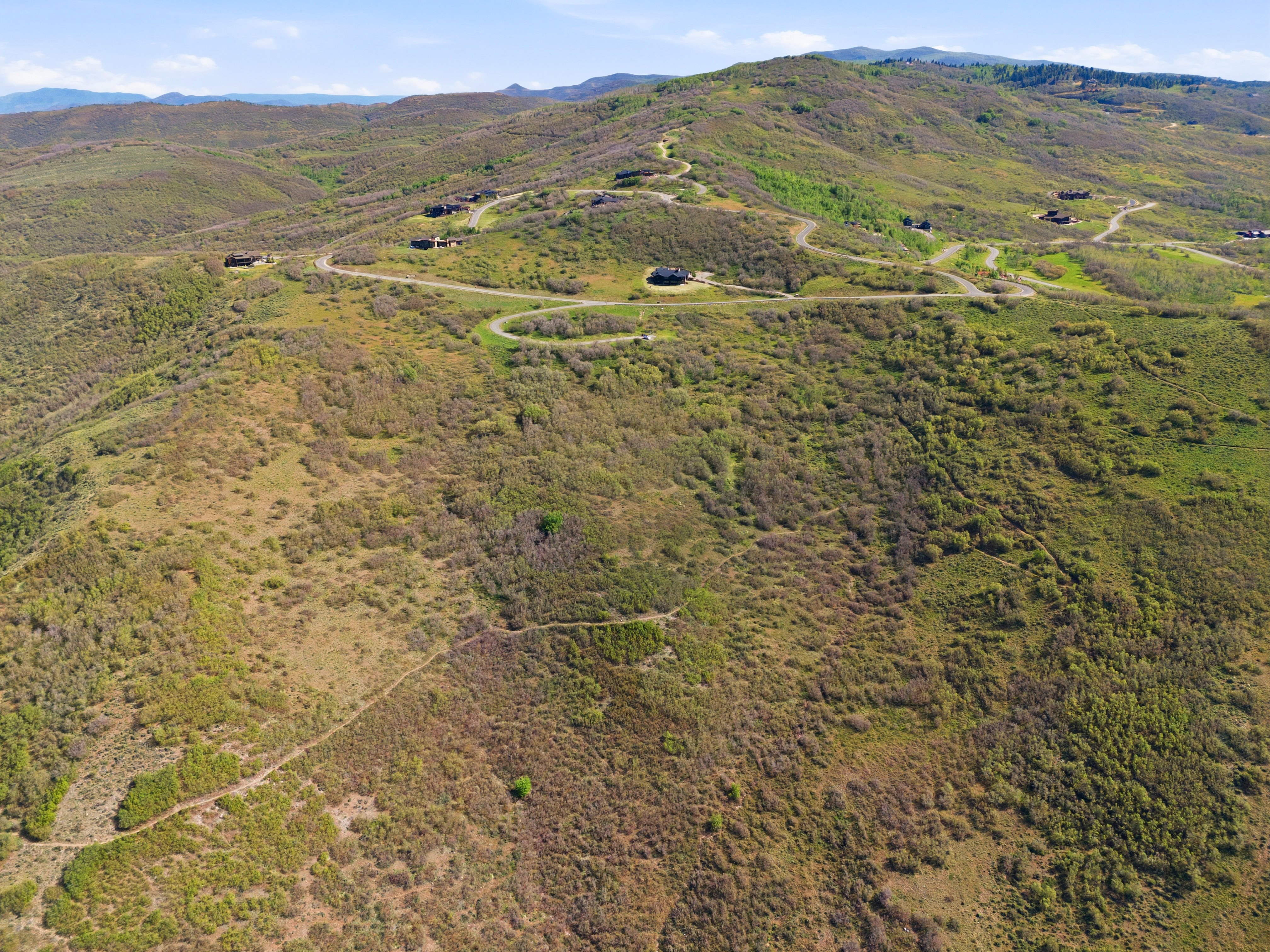 Expansive mountain terrain with scattered residential structures