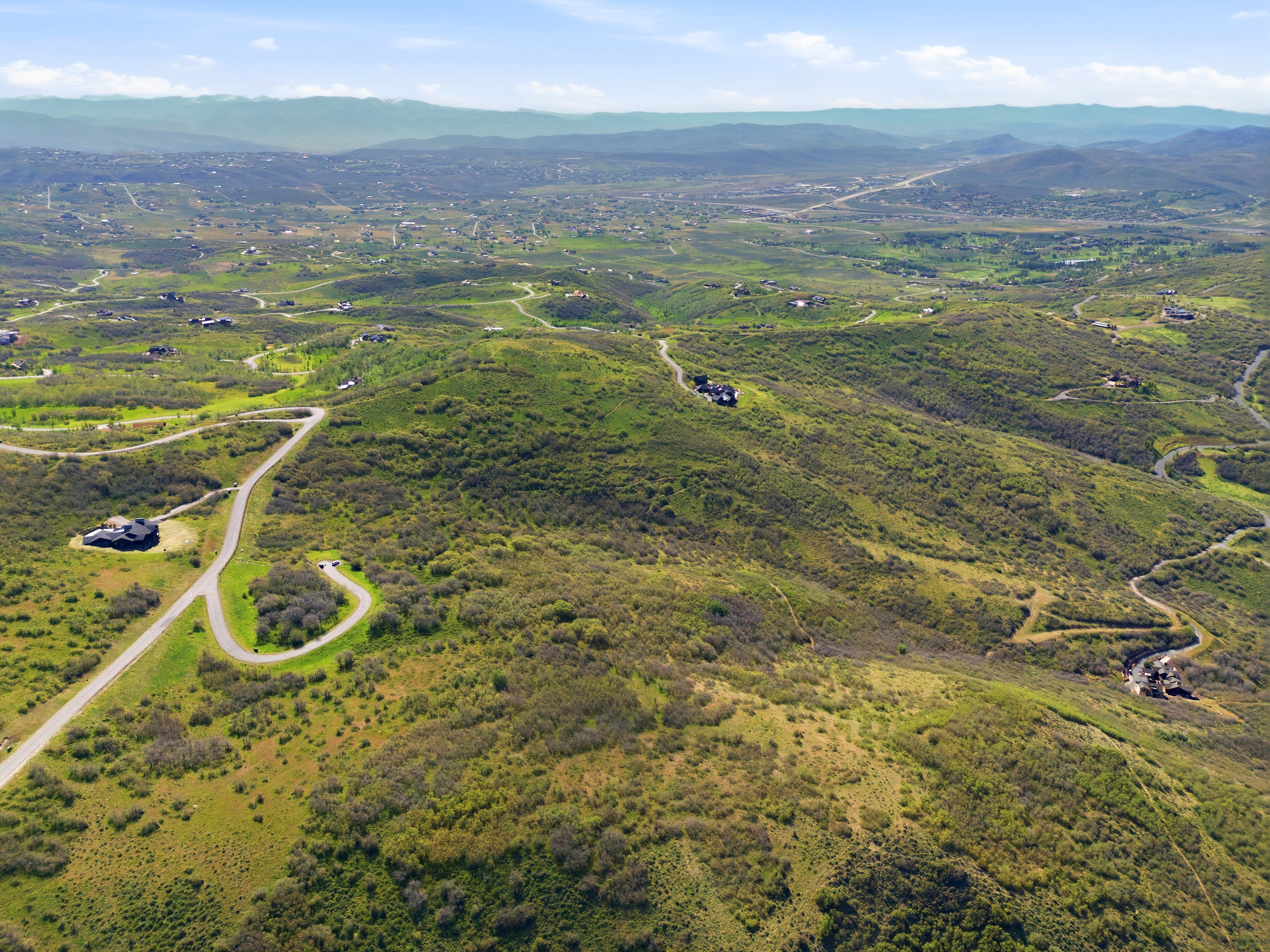 Expansive landscape with rolling hills and abundant green foliage