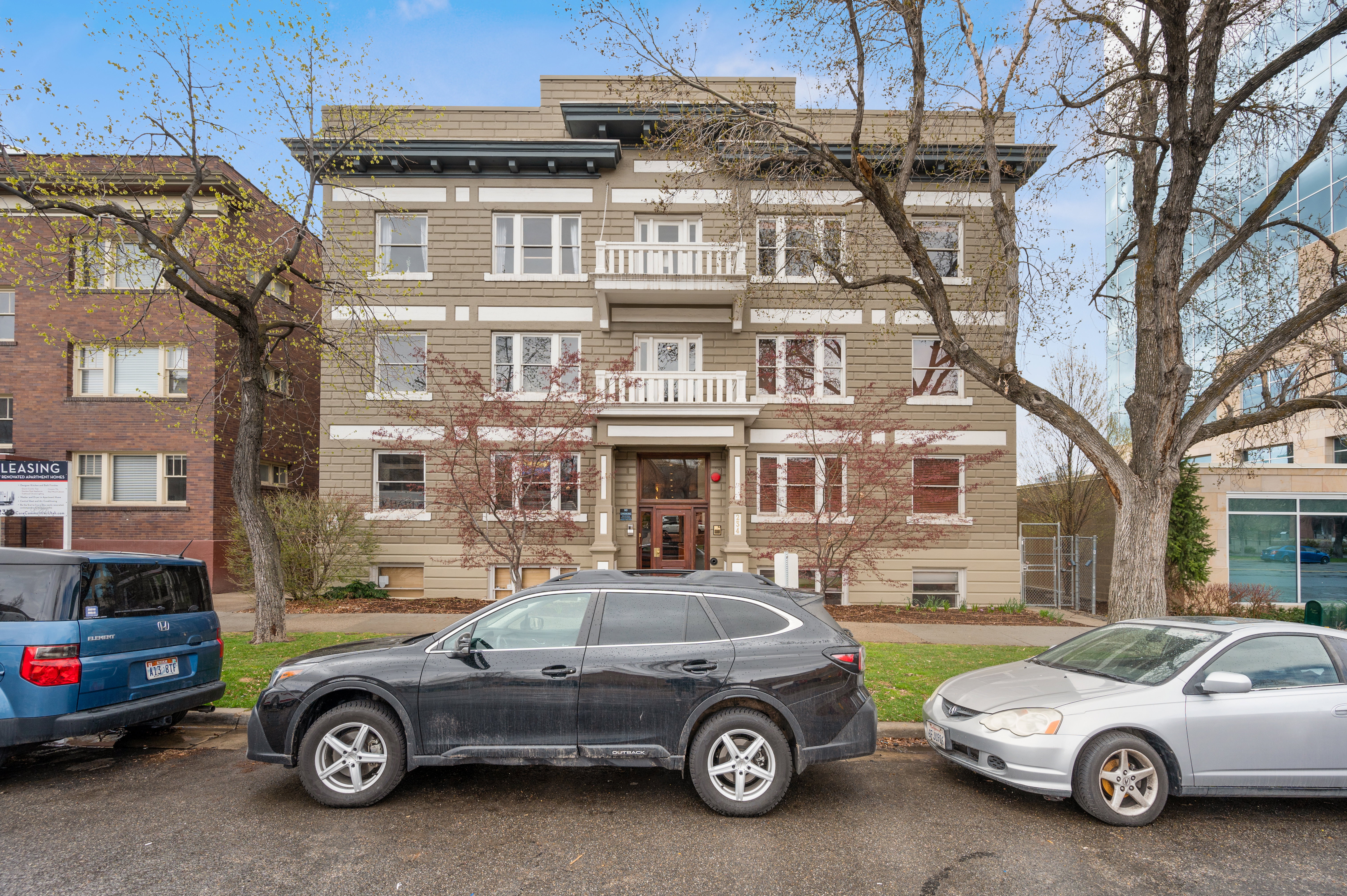 Multi-story building featuring a neutral-toned facade with decorative trim work