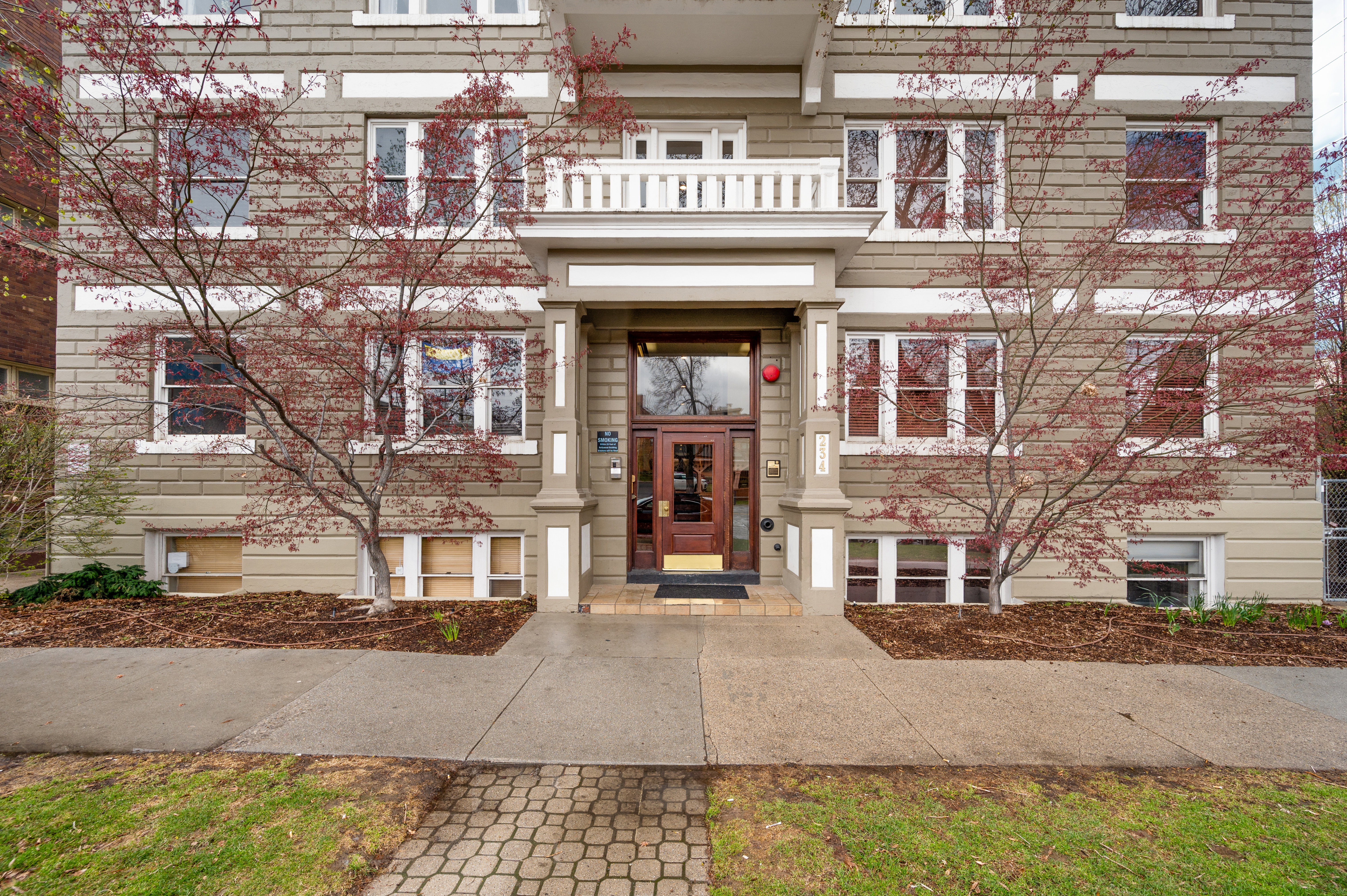 Multi-story building facade featuring horizontal siding and white trim accents