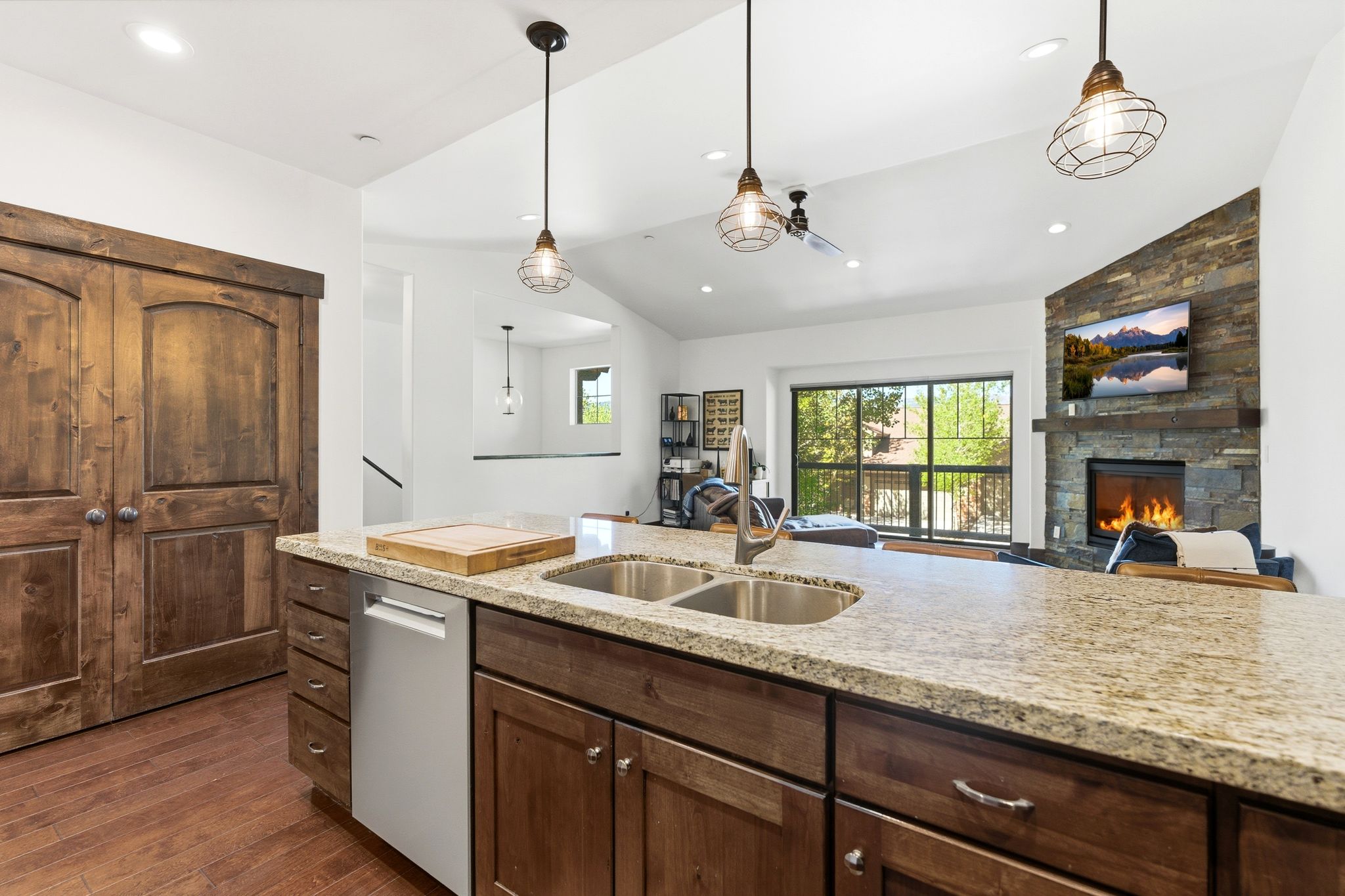 Kitchen island featuring an undermount double-basin stainless steel sink and a gooseneck faucet