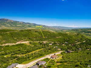 Mountainous landscape with expansive green foliage under a clear blue sky