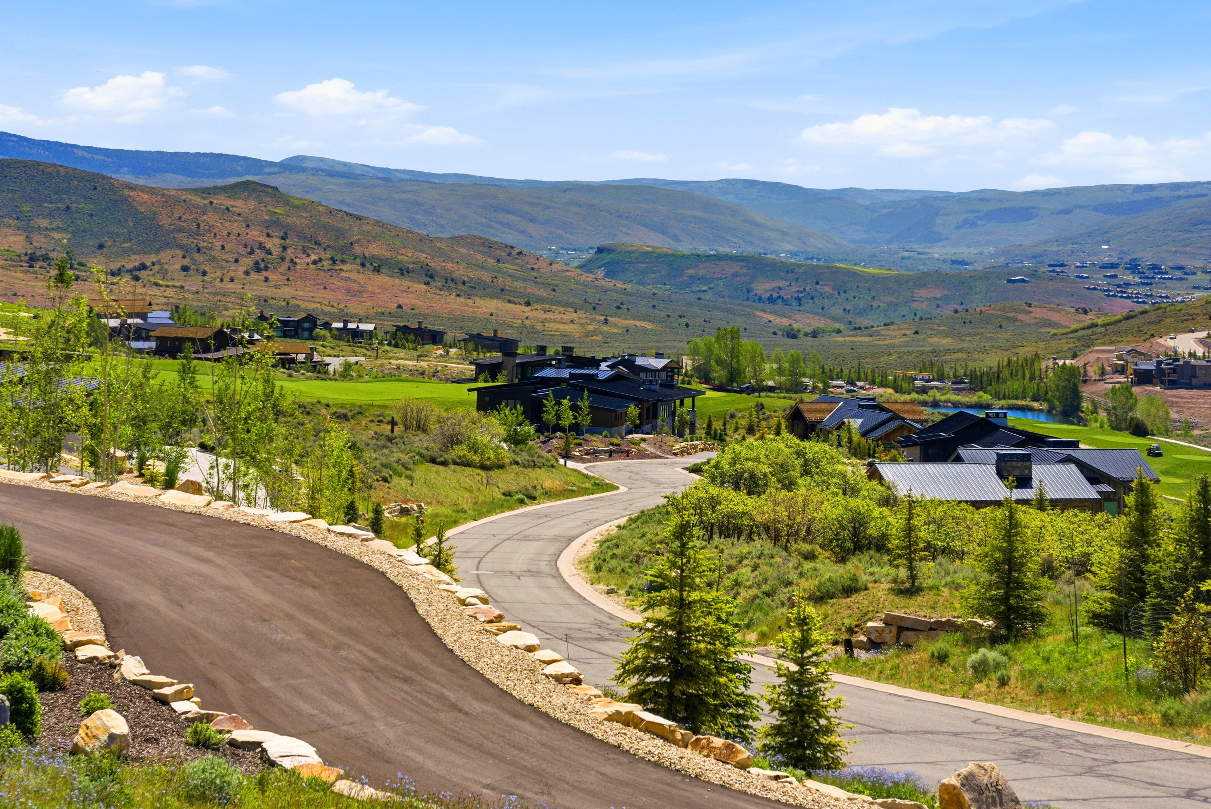 Winding paved roadways bordered by natural rock landscaping