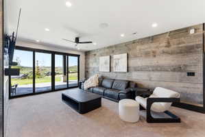 Spacious room featuring a full wall of sliding glass doors, recessed lighting, and a contemporary ceiling fan