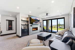Living area featuring a contemporary fireplace with a tiled surround, built-in shelving, and direct patio access through large glass sliding doors