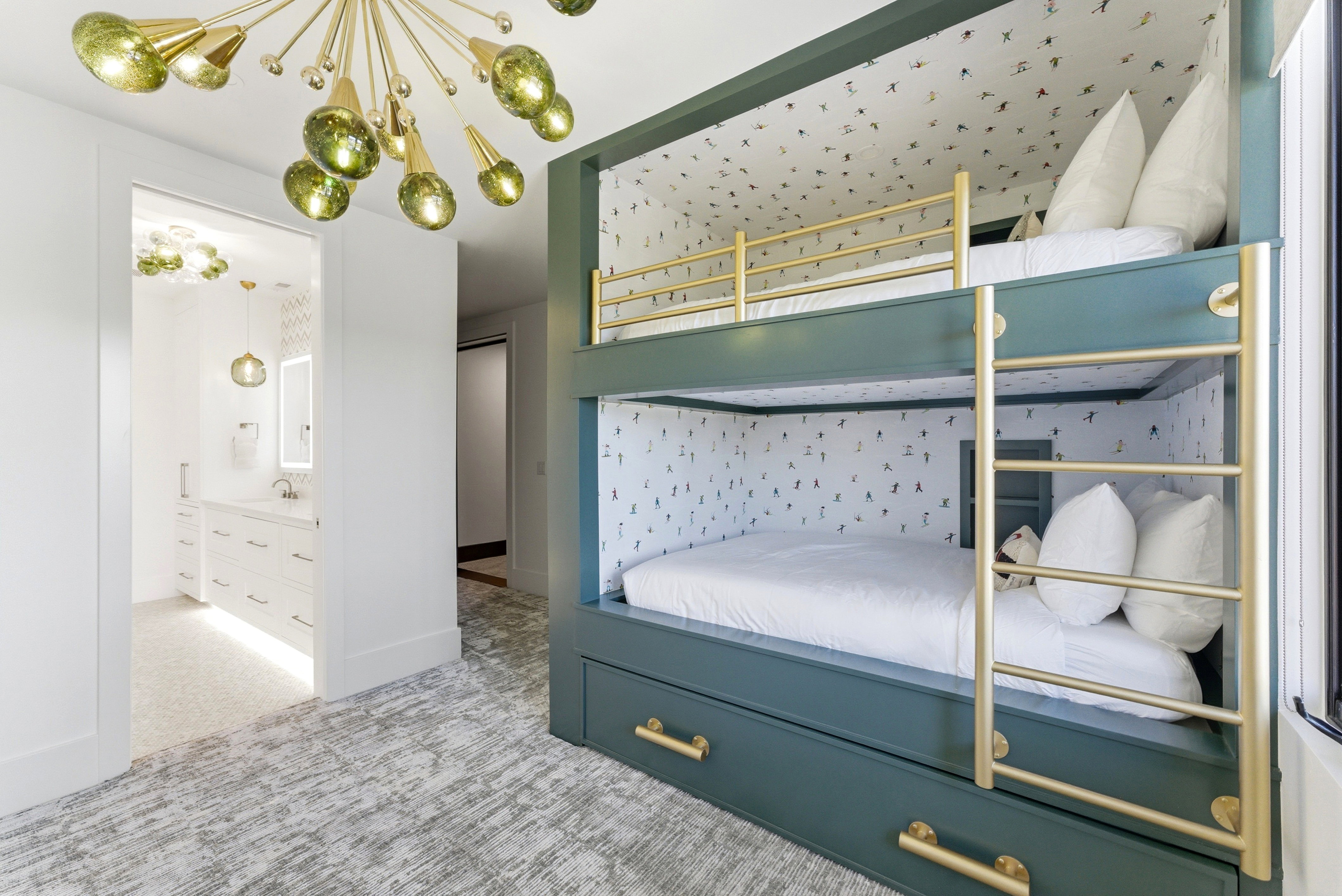 Custom built-in bunk beds with integrated storage drawers and gold-finish hardware