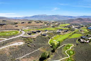 Expansive aerial perspective showcasing a golf course community with numerous fairways and greens