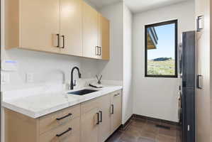 Laundry area featuring a large window with desert scenery